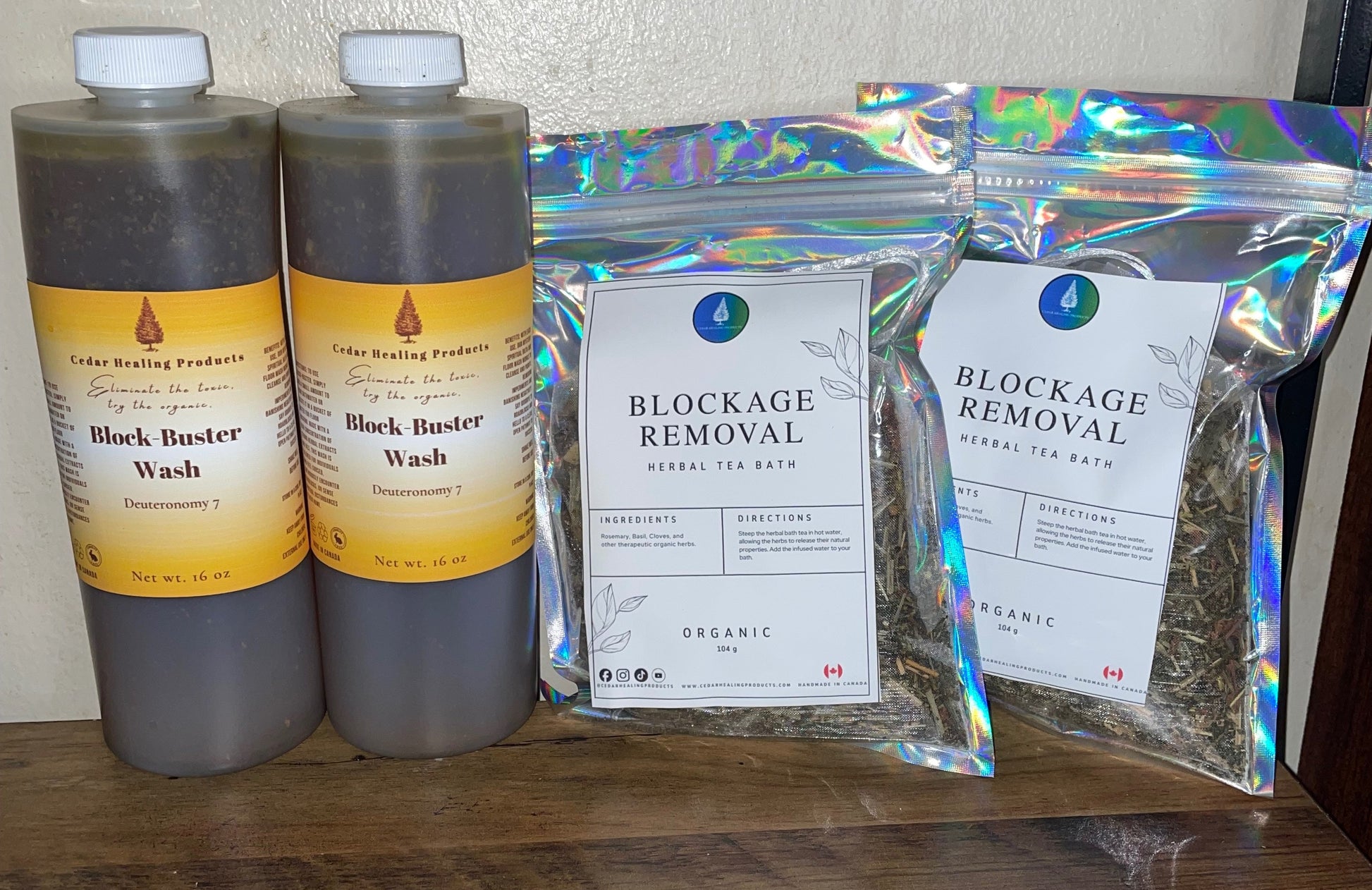 Two bottles of 'Black Buster Wash' and two packages labeled 'Blockage Removal' on a wooden shelf.