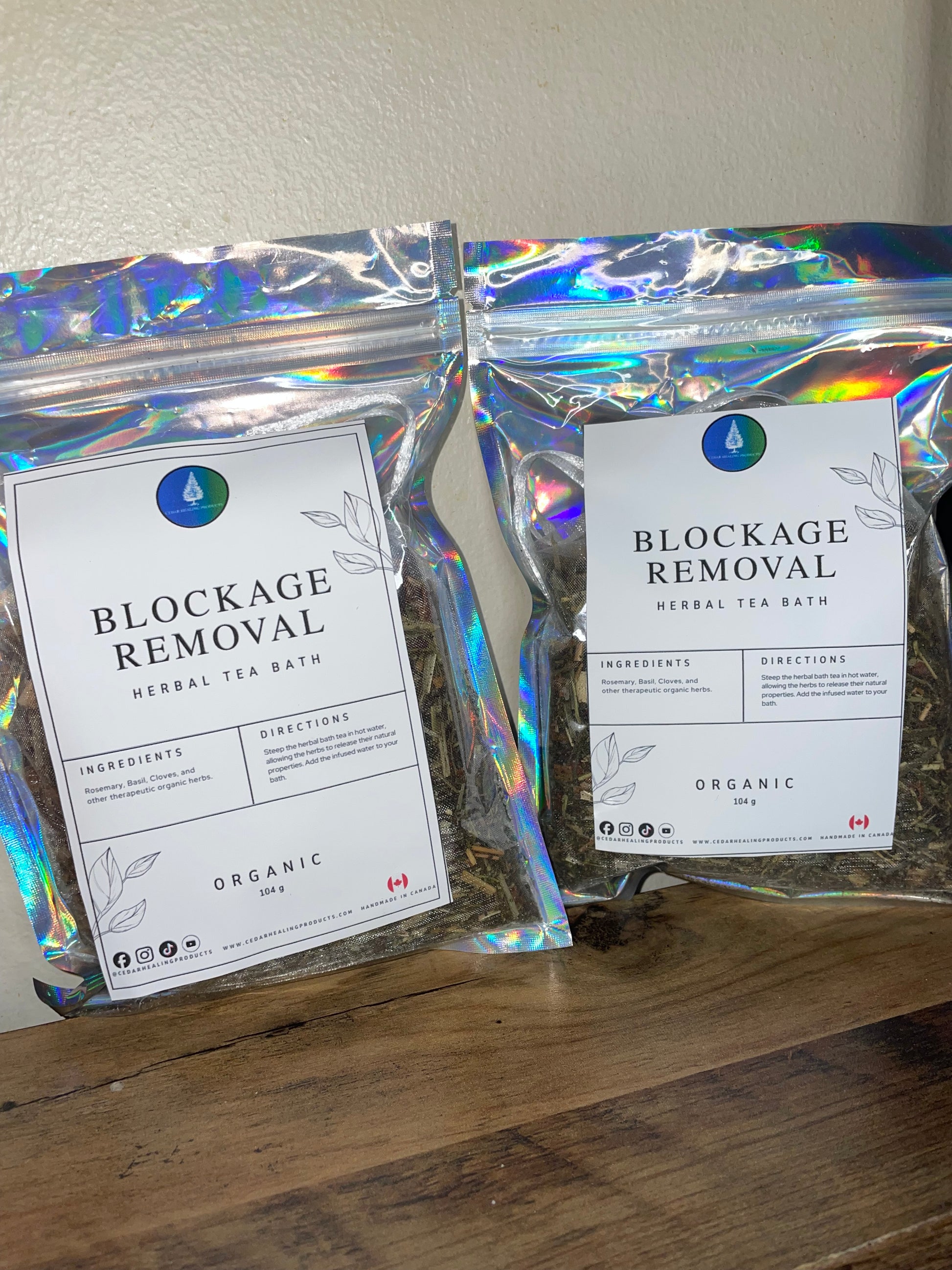 Two packages of 'Blockage Removal' herbal tea on a wooden surface.