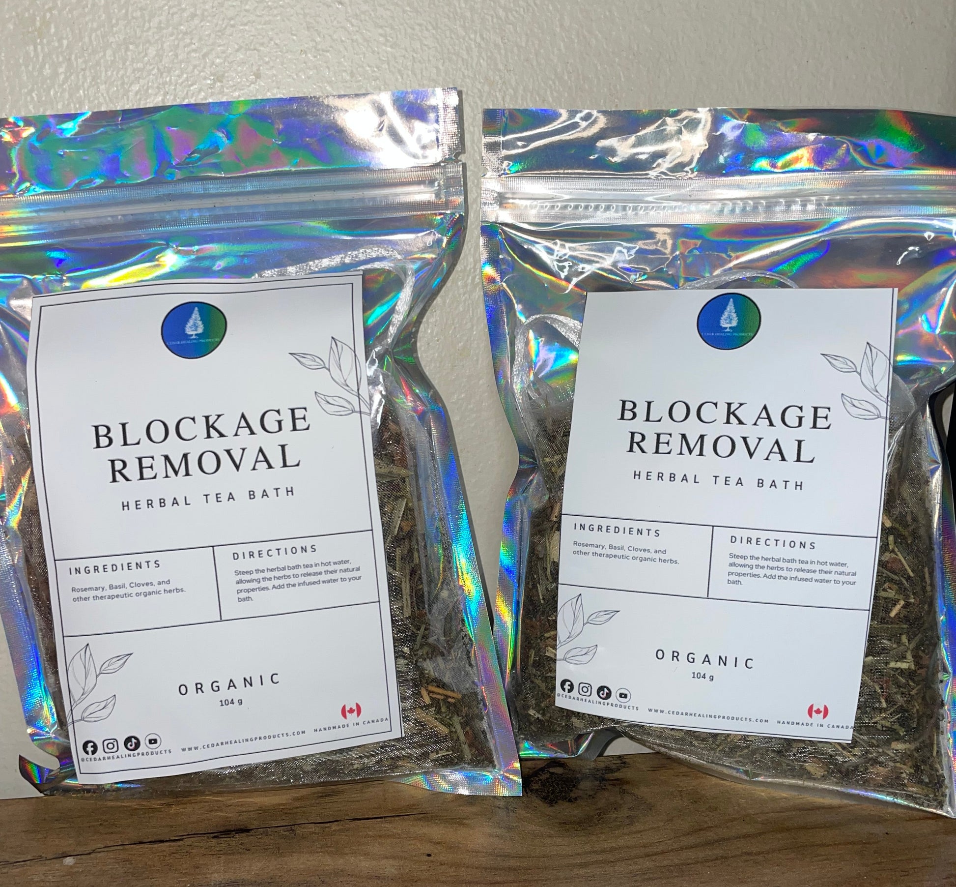 Two packages of 'Blockage Removal' herbal tea on a wooden surface.