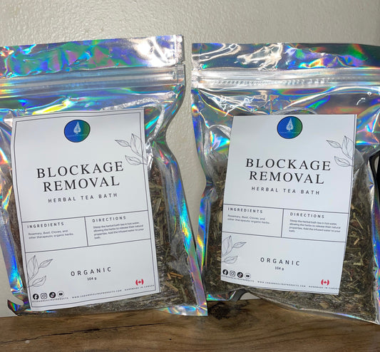 Two packages of 'Blockage Removal' herbal tea on a wooden surface.