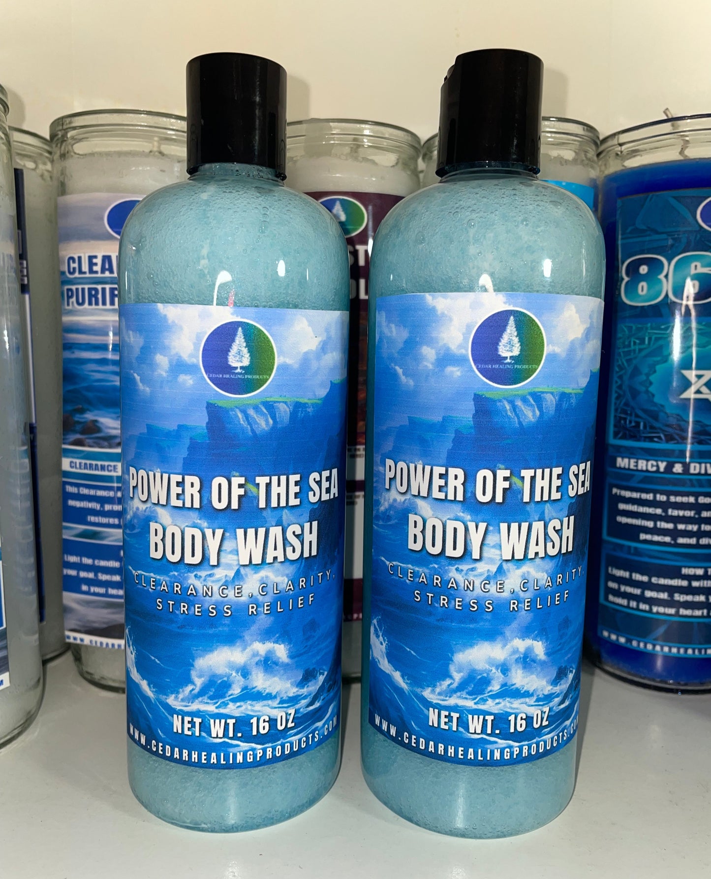 Two bottles of Sea Oracle 'Power of the Sea' Body Wash standing on a white surface, with other bottles partially visible in the background.
